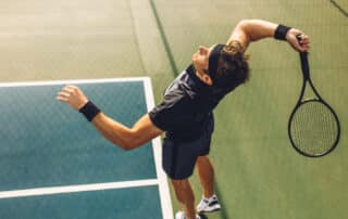 Tennis player serving in the match