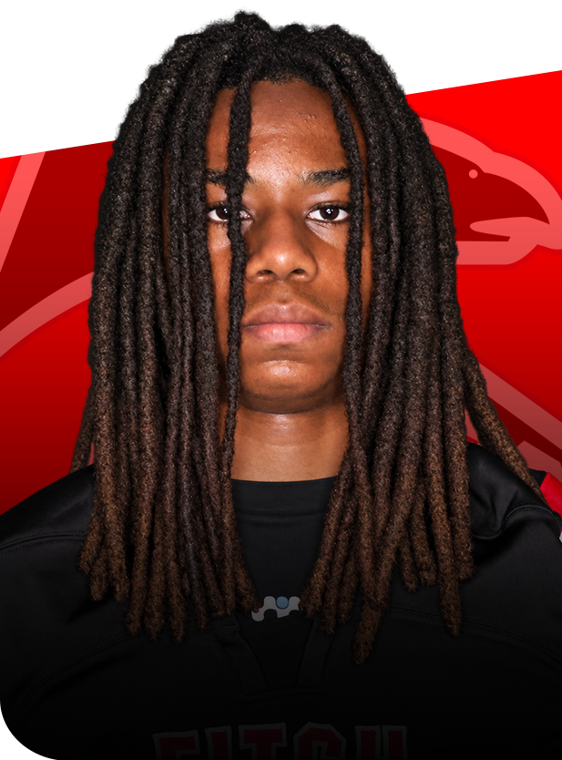 Cam Connor football senior groton ct Portrait of Cam Connor in his black football jersey against a red background with a falcon logo.